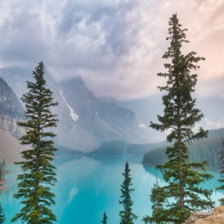 Moraine Lake view from Rockpile Trail with mix of gray and golden skies from wildfire smoke, thunderstorm clouds, and sunset