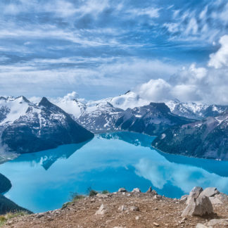 Summit of Panorama Ridge looking down on Garibaldi Lake surrounded by mountains and blue skies in Garibaldi Provincial Park