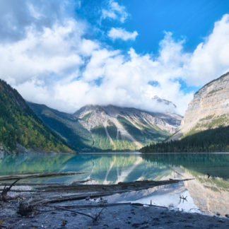 Whitehorn Mountain reflected in Kinney Lake covered in clouds on Berg Lake Trail in Mount Robson Provincial Park