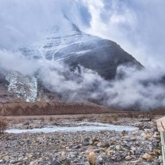 Mount Robson enshrouded in fog by bridge near Marmot campground on Berg Lake Trail in Mount Robson Provincial Park